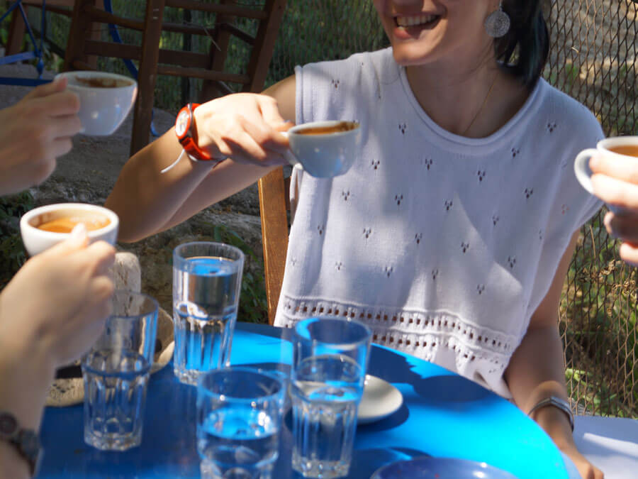 Friends enjoying Greek coffee during a food tour in Athens